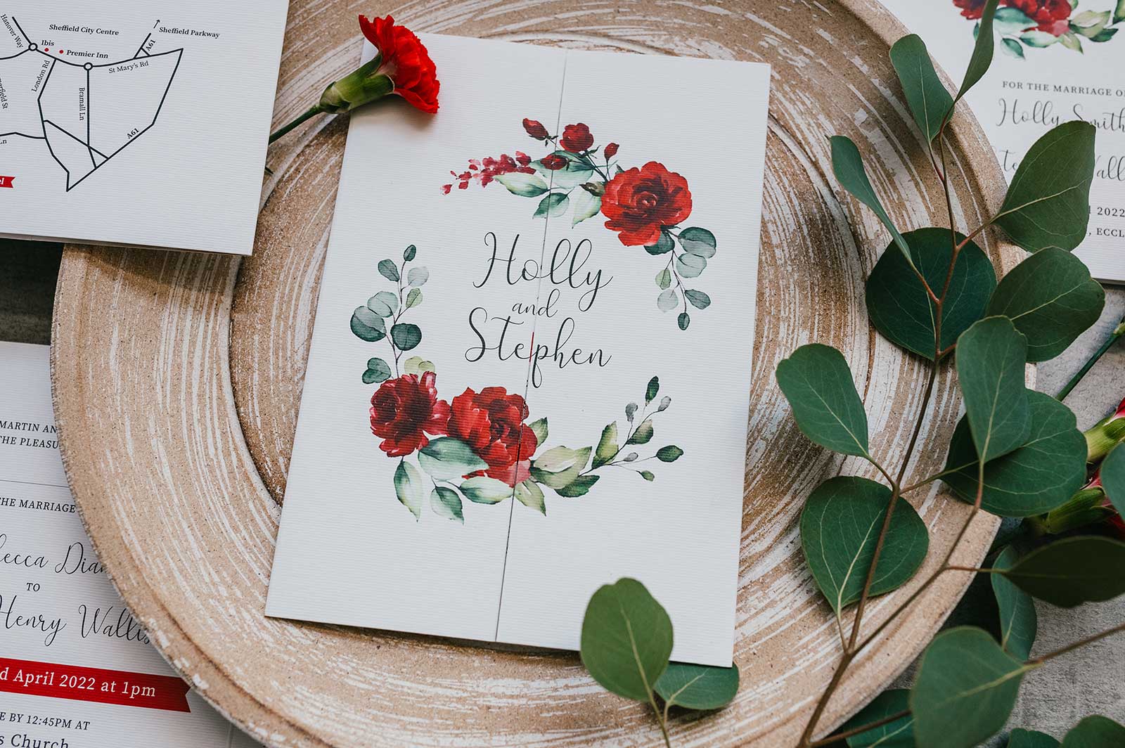 red roses and eucalyptus wedding stationery