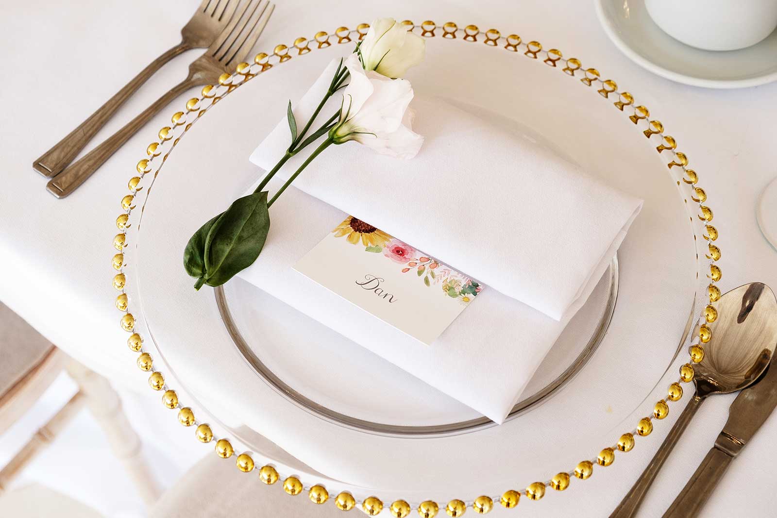 floral place name card with napkin on charger plate