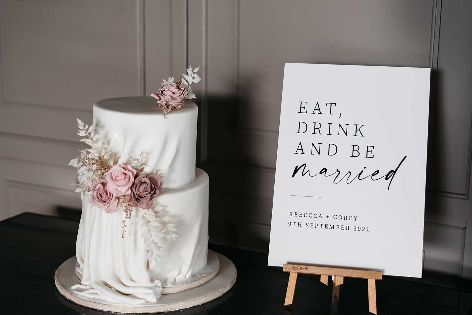 elegant wedding cake and wedding sign